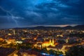 Lightning storm with dramatic clouds over the city of Graz, with Mariahilfer church and historic buildings, in Styria region, Royalty Free Stock Photo