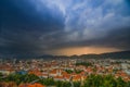 Lightning storm with dramatic clouds over the city of Graz, with Mariahilfer church and historic buildings, in Styria region, Royalty Free Stock Photo