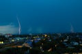 Lightning storm over city in blue light Royalty Free Stock Photo