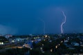 Lightning storm over city in blue light Royalty Free Stock Photo