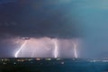 Lightning storm over city. Lightning strike over dark blue sky in night city Royalty Free Stock Photo