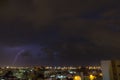 Lightning storm over city in purple light in jeddah al marwah Royalty Free Stock Photo