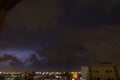 Lightning storm over city in purple light in jeddah al marwah Royalty Free Stock Photo