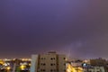 Lightning storm over city in purple light in jeddah al marwah Royalty Free Stock Photo