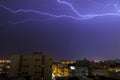 Lightning storm over city in purple light in jeddah al marwah Royalty Free Stock Photo