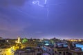 Lightning storm over city in purple light in jeddah al marwah Royalty Free Stock Photo