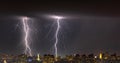 Lightning storm over the city at the summer heavy rain. Dramatic, breathtaking atmospheric natural phenomenon. Kyiv, Ukraine