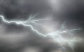 Lightning storm over the city at the summer heavy rain Royalty Free Stock Photo