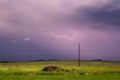 Lightning streaks across a rainy sky in the evening.