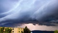 A lightning strike behind a massive shelf cloud over the city Usti nad Labem Royalty Free Stock Photo