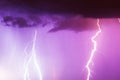 Lightning strike on the dark cloudy sky. Pink and purple and red toned image Royalty Free Stock Photo