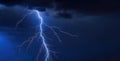 Lightning strike during an electrical storm thunder.The strongest electric charge on a dark blue sky background.