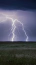 Lightning strike on prairie horizon during electrifying storm scene Royalty Free Stock Photo