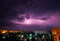 Lightning strikes down over the city at night. Royalty Free Stock Photo