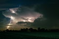 Lightning strikes down from the top of the thunderstorm, outside the storm cloud Royalty Free Stock Photo