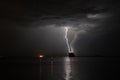 Lightning strikes at sea near a ship Royalty Free Stock Photo