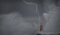 Lightning and wave over old lighthouse. Royalty Free Stock Photo