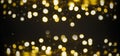 Lights in bokeh background. Yellow and gold lights in bokeh on a black dark background. Holiday, background decoration concept Royalty Free Stock Photo