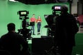 Lights.. Camera.. Action! Woman and Man anchor reporting news in studio Royalty Free Stock Photo