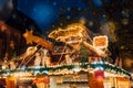 Christmas market spirit during snow night. Celebrating Xmas holidays. Royalty Free Stock Photo