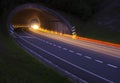 Lights of the cars on the road to the tunnel. Royalty Free Stock Photo