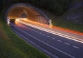 Lights of the cars on the road to the tunnel. Royalty Free Stock Photo