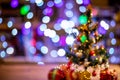 Lights and christmas tree on colorful defocused background Royalty Free Stock Photo