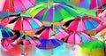 The lights and the colors of the rainbow reflected in the umbrellas towards the sky