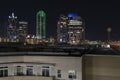 Lights of the Dalllas skyline at night behind apartment building