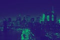 Lights of the downtown Manhattan skyline at night in New York City with green and blue duotone colors Royalty Free Stock Photo
