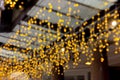 lights of an electric garland on the street in defocus. New Year and Christmas festive decor