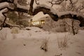 Lights of a home seen from outdoors on a snowy night Royalty Free Stock Photo