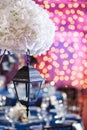 Lights and lanterns in the night. Bokeh Wedding Banquet. The chairs and round table for guests.