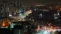 The lights of the night city. View of the busy city traffic and the light from the headlights of cars at night. The lights are on