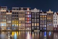 Lights at night in traditional row houses on a canal in Amsterdam Royalty Free Stock Photo