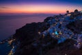 Lights of Oia village at night, Santorini, Greece.