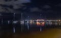 The marina and moored yachts in a night photo with lights and reflections Royalty Free Stock Photo