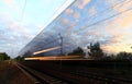 The lights of a speeding train crossing the railroad tracks Royalty Free Stock Photo