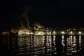 Lights and steam coming from an industrial site in the pre-dawn darkness