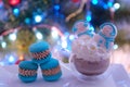 a cup of cocoa with cream two meringue snowmen macaroons on the background of a Christmas tree Christmas celebration Royalty Free Stock Photo