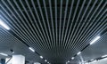 Lights and ventilation system in long line on ceiling of the dark office industrial building exhibition Hall Ceiling construction. Royalty Free Stock Photo