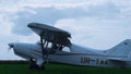 Lightweight airplane landing airfield with spinning propeller turning off engine Royalty Free Stock Photo