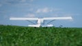 Lightweight airplane standing grass with spinning propeller. Plane ready flight. Royalty Free Stock Photo