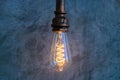 Light bulb hanging of the wall. Edison style light bulb.filament lamp for interior lighting vintage style decoration Royalty Free Stock Photo