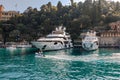 Italy, Europe. Luxury yachts and boats in The beautiful Portofino with colorful houses and villas, in little bay harbor