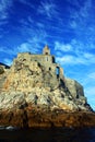 Liguria: the Saint Peter church of Portovenere on the cliff rockview and blue sky with clouds from the boat in the afternoon Royalty Free Stock Photo