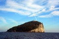 Liguria: view from the boat of the island of Tino with sea rock trees sky and clouds Royalty Free Stock Photo