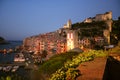 View of colored buildings of Portovenere at dawn with tower, cathedral, cathedral and harbor with moored boats