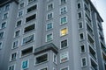 Liht in a single window of an apartment building at dawn