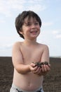 The liitle boy with black earth Royalty Free Stock Photo